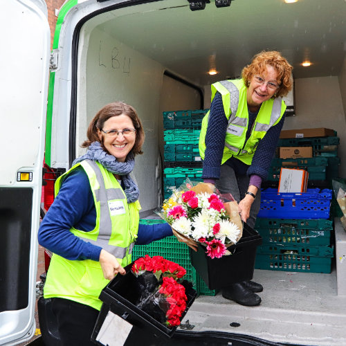 Volunteers Unloading Food And Flowers From A Felix Van