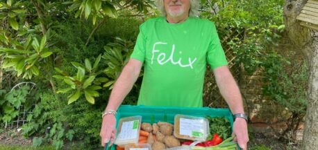 James May wearing a Felix t-shirt, holding crate of food