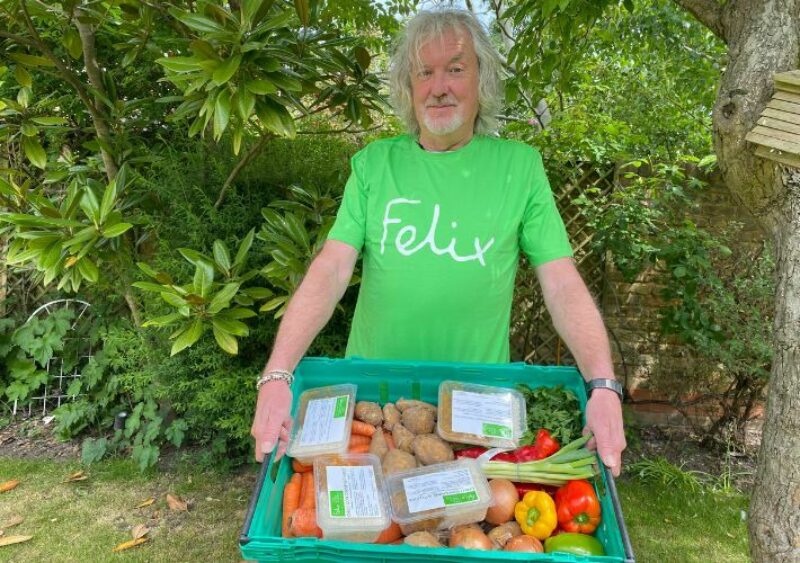 James May wearing a Felix t-shirt, holding crate of food