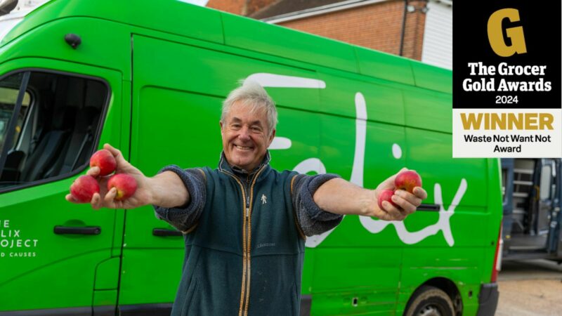 Man standing in front of Felix van holding apples with The Grocer Awards 2024 winner logo overlayed